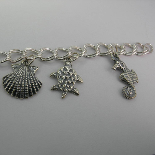 Close up of Sea Shell and Sea Turtle and Sea Horse on Nautical Charm Bracel