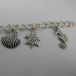 Close up of Sea Shell and Sea Turtle and Sea Horse on Nautical Charm Bracel