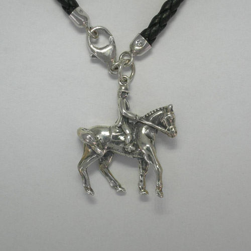Close of of right side of horse and rider charm