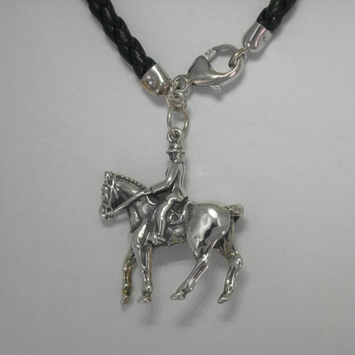 close up of left side of rider and horse charm