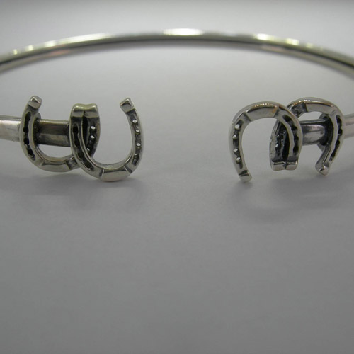 Close up of horseshoes on horseshoe bangle bracelet