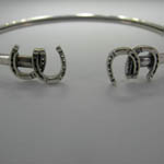 Close up of horseshoes on horseshoe bangle bracelet