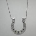 Custom 14 karat white gold horse shoe necklace close up