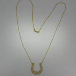 Custom 14 karat yellow gold and diamond horseshoe necklace