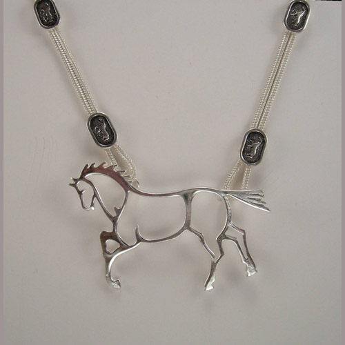 close up of abstract horse necklace
