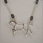 close up of abstract horse necklace