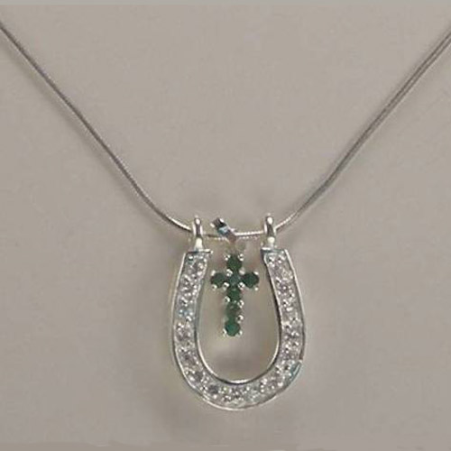 close up of gemstone cross inside horseshoe necklace