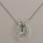 close up of gemstone cross inside horseshoe necklace
