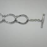 close up of toggle half of horseshoe link bracelet