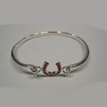 side view of ruby horseshoe bangle bracelet