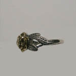 side view of silver and gold flower ring