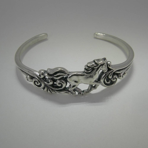 side view of Sterling Silver galloping horse cuff bracelet with filigree