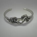 side view of Sterling Silver galloping horse cuff bracelet with filigree