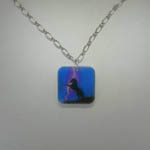 Acrylic rearing black horse in storm necklace.